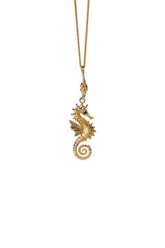 a gold necklace with a seahorse on it