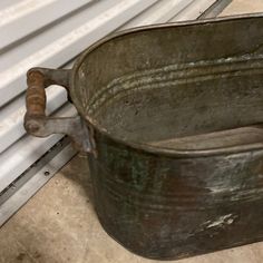 an old metal bucket sitting next to a radiator