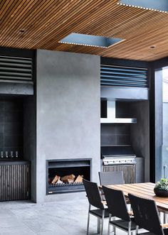 a dining room table with chairs and a fire place