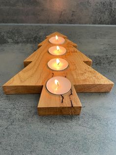 four candles are arranged in the shape of an arrow