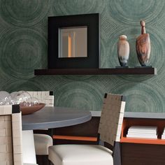 a dining room table with two vases on top of it and a mirror in the background