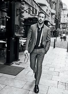 a man in a suit walking down the street