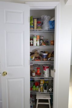 an open pantry door with shelves full of food