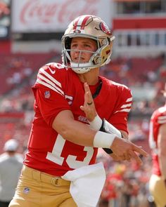 a close up of a football player throwing a ball