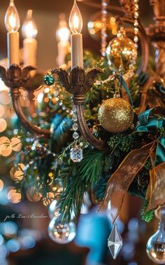 a chandelier with candles and ornaments on it