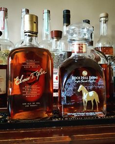 several bottles of liquor sitting on top of a shelf