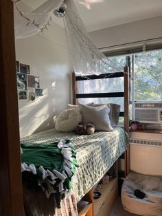 a bedroom with a bed, window and air conditioner