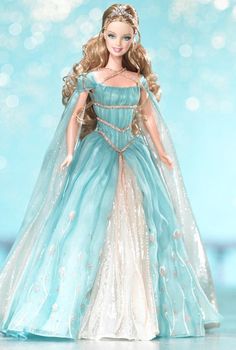 a barbie doll wearing a blue gown and tiara