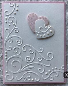 a close up of a greeting card with a heart on the front and an embellishment in the middle