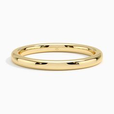 a yellow gold wedding band with rounded edges and an oval design on the inside of it