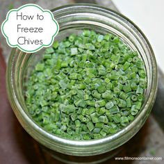 a jar filled with green chives sitting on top of a table