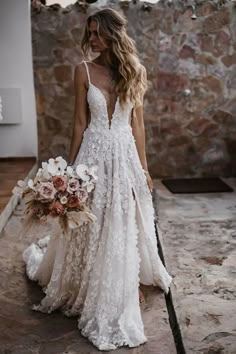 a woman in a wedding dress holding a bouquet