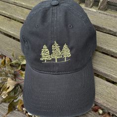 "Black Baseball Cap with Olive Pine Trees embroidered of the front. Camping and Hiking hat. Life of Trees 100% Superior Cotton Twill Garment Washed Unstructured 6 Panel Baseball Hat 6 eyelets 6 Rows Stitching on Visor Adjustable Metal Buckle Antique Brass Finish Size: Unisex (58cm/22.8\")" Casual Embroidered Hats For Outdoor, Outdoor Embroidered Trucker Baseball Cap, Embroidered Trucker Hat For Outdoor, Casual Baseball Cap With Embroidered Logo For Outdoor, Embroidered Outdoor Baseball Cap, Black Baseball Cap With Custom Embroidery, Casual Black Hat With Custom Embroidery, Casual Black Baseball Cap For Camping, Outdoor Embroidered Hat With Curved Brim