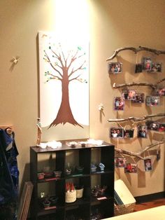 a living room filled with furniture and pictures hanging on the wall next to a book shelf