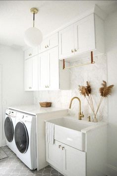 a washer and dryer in a white kitchen