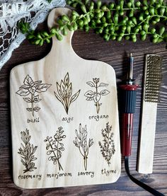 a wooden cutting board with different herbs on it next to a brush and some other items