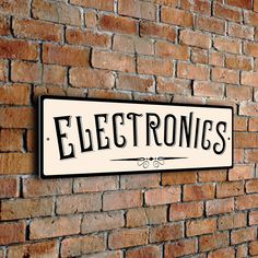 a brick wall with a sign that says electronics on it and the word electronics written in black