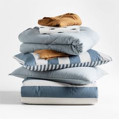 pillows stacked on top of each other in front of a white background