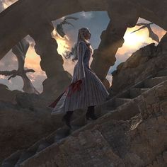 a woman is walking up some steps in front of an alien like structure at sunset