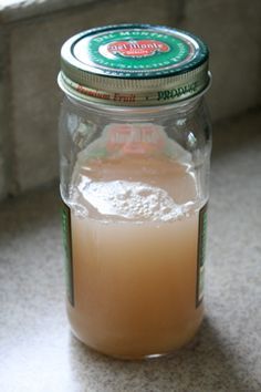 a glass jar filled with liquid sitting on top of a counter