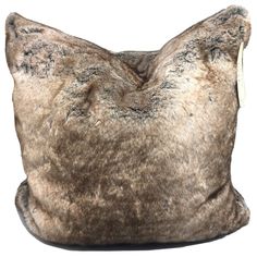 a brown and black animal print pillow on a white background with a tag in the middle