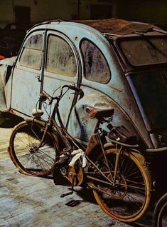 an old car with a bike attached to it