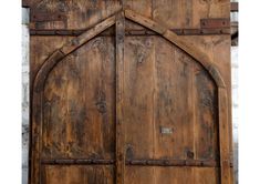 an old wooden door with metal handles