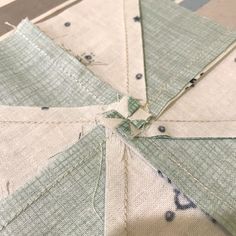 the fabric has been stitched together to make an origami style star pattern