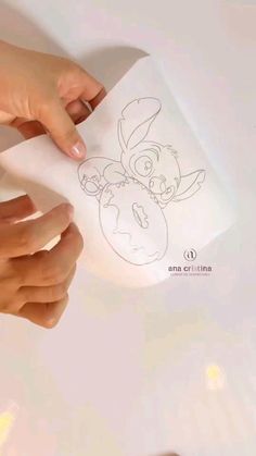 someone is drawing an image on a piece of paper with their hands and thumbnails