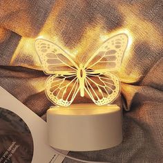 a yellow butterfly light sitting on top of a table