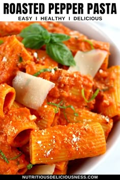 pasta with tomato sauce and parmesan cheese in a white bowl