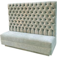 an upholstered couch with buttons on it's back and seat padding