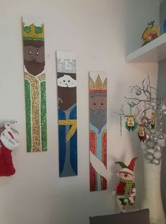 three christmas decorations are hanging on the wall