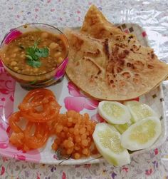 a plate with some food on it and a bowl of sauce next to the dish