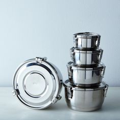 several stainless steel pots stacked on top of each other