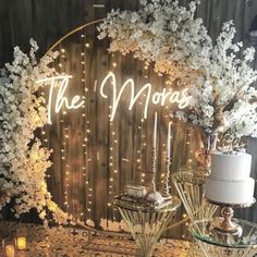 a table topped with cake and candles next to a sign that says the m'mores