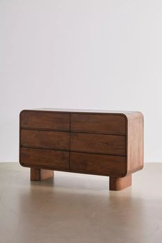 a wooden dresser sitting on top of a white floor