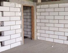 an unfinished room with a fire hydrant in the center and brick walls around it