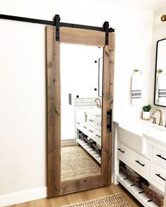 a bathroom with a large mirror and sliding door in it's center area, next to a sink