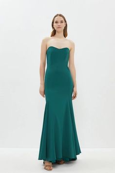 a woman in a long green dress