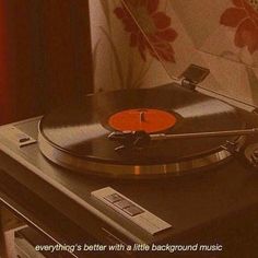 an old record player sitting on top of a table