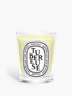 a candle that is sitting on top of a white surface with the words tu beu se in it