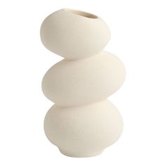 a white vase sitting on top of a table