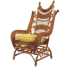 a wicker rocking chair with a cushion on the back and armrests is shown