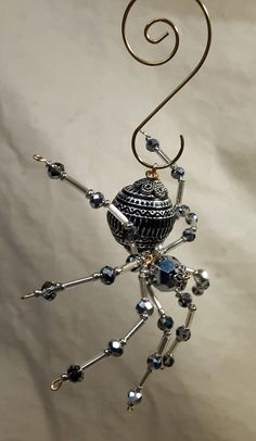 a wire sculpture with a spider on it's back