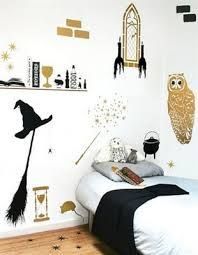 a bedroom decorated with harry potter wall decals and hogwarts decorations on the walls