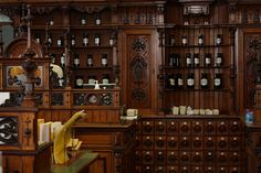 a room with many wooden shelves and clocks