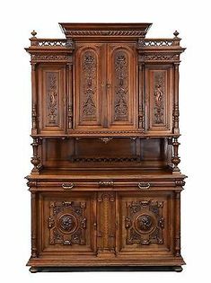 an old fashioned wooden cabinet with carvings on the front and side panels, inlaid to wood