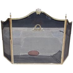 an old iron fireplace screen with a football on the ground in front of white background