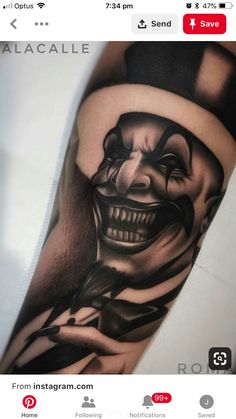 a man's arm with a joker tattoo on it